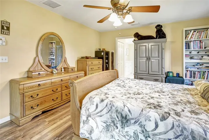 Bedroom with ceiling fan and light hardwood / wood-style floors