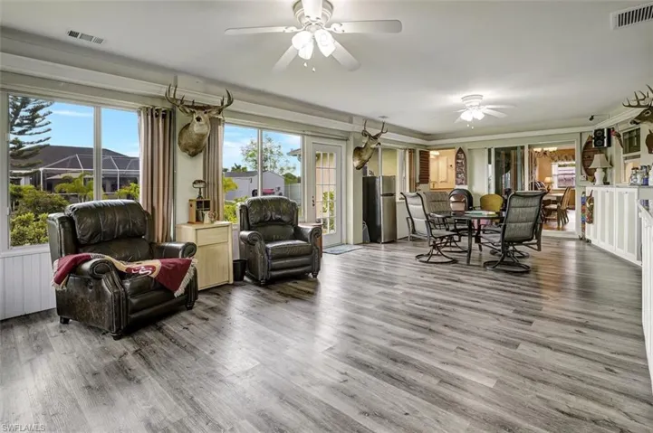 Sun room with hardwood / wood-style flooring and ceiling fan