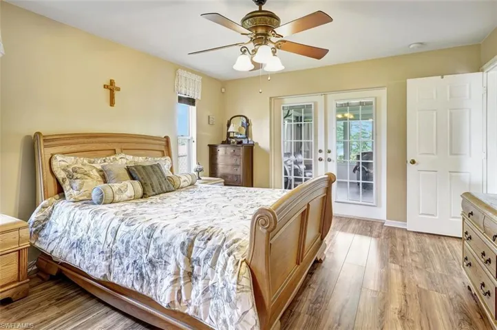 Bedroom featuring ceiling fan, french doors, access to outside, and wood-type flooring