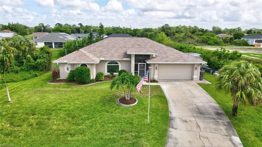 Ranch-style home featuring a garage and a front yard