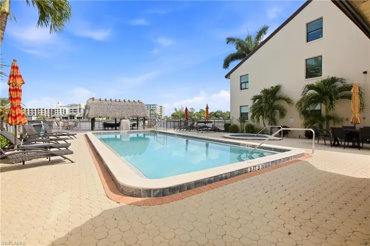 Rectangular swimming pool surrounded by paver patio