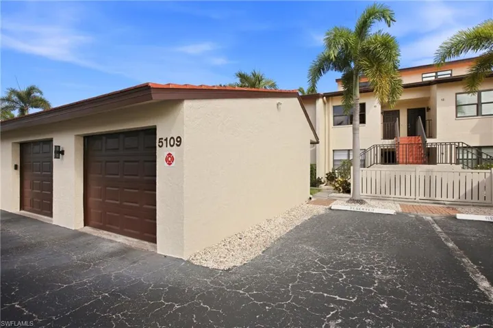 1-car garage with paneled doors and stucco exterior