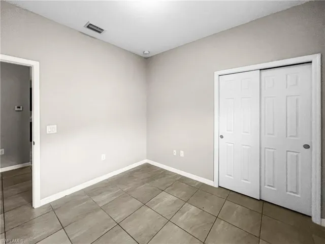 Neutral tone walls paired with large format tile flooring