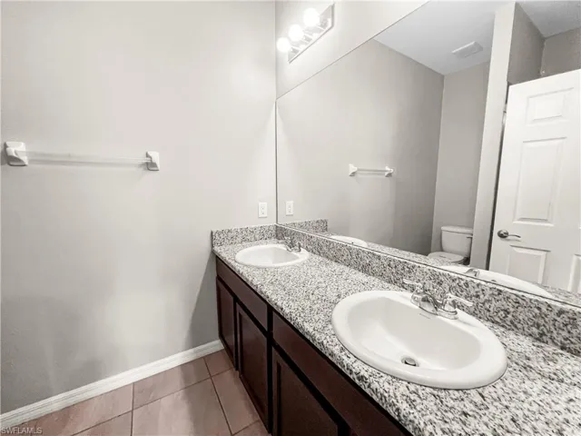 Dual vanity with granite-style countertop and undermount sinks