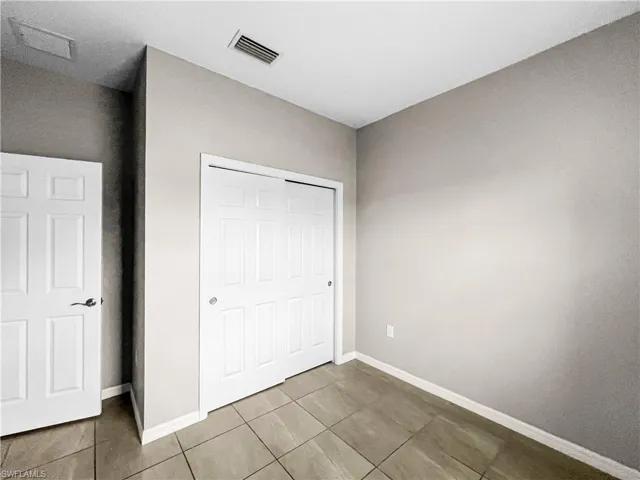 Room featuring neutral wall paint, white baseboards, and ceramic tile flooring