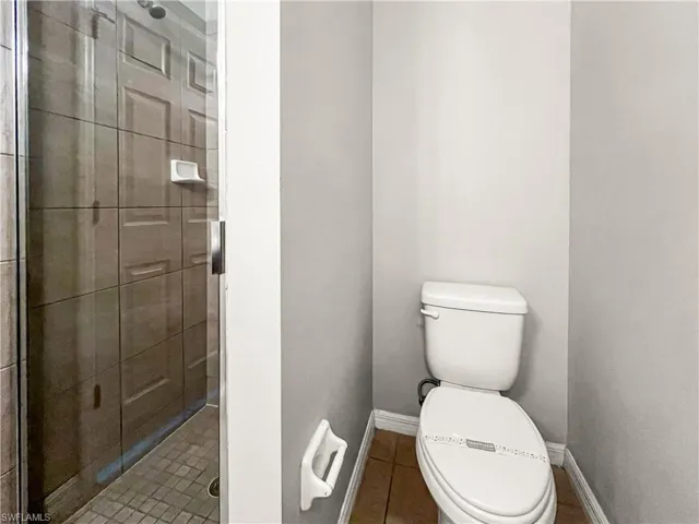 Shower enclosure with glass door and rectangular tile surround