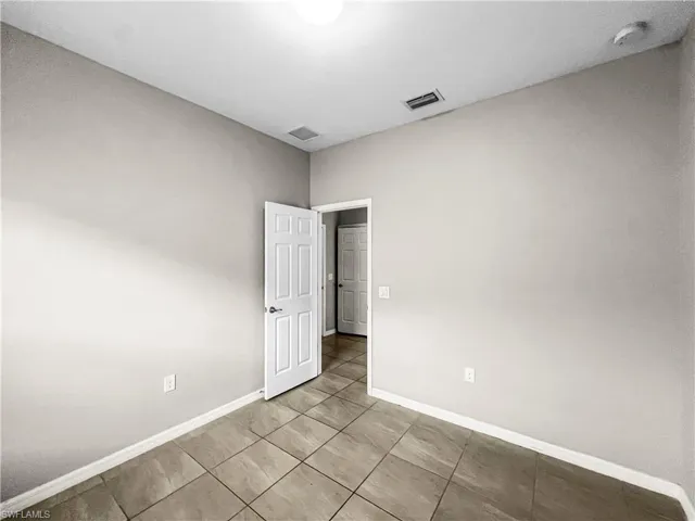 Interior room featuring neutral wall tones and tile flooring