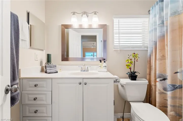 Full bath featuring vanity and toilet