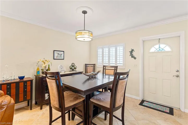 Dining area featuring ornamental molding and baseboards