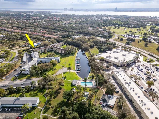Birds eye view of property with a water view