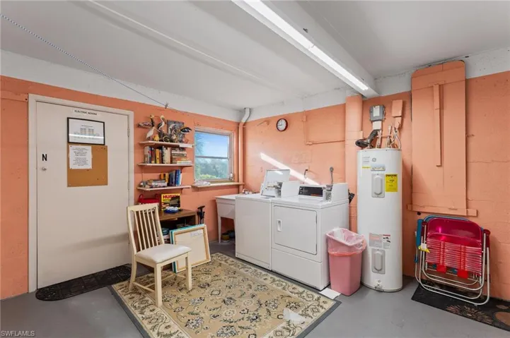 Laundry area featuring water heater and washer and dryer