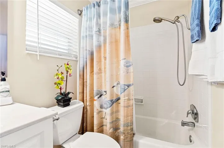 Full bathroom featuring toilet and shower / bath combo