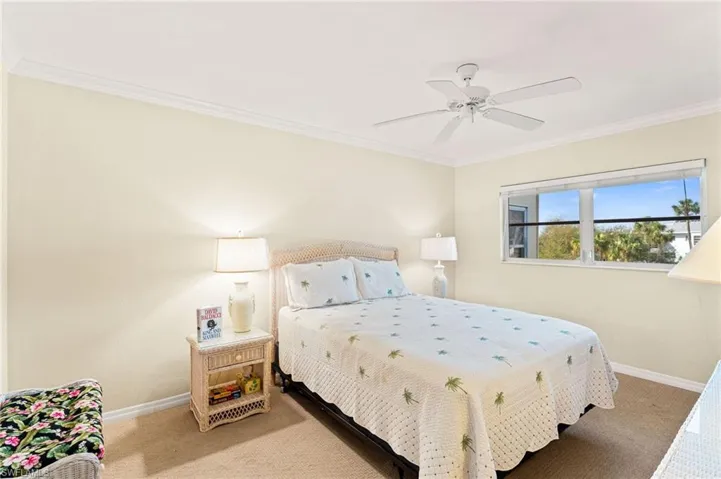 Primary Bedroom featuring ornamental molding, carpet flooring, and baseboards