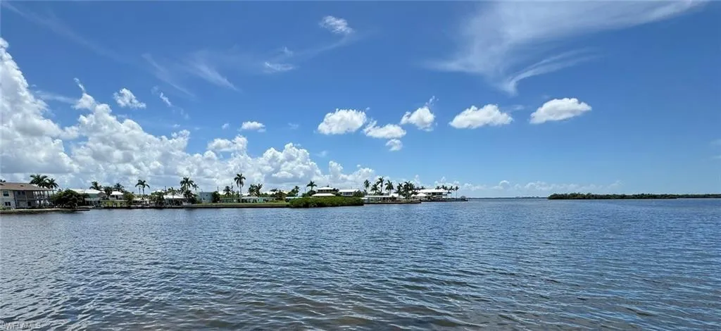 VIEW FROM THE POOL, SEAWALL/ BOAT RAMP AND MAIN LIVING ROOM