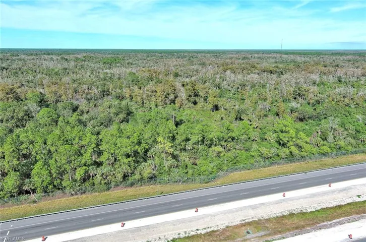 Aerial overview of property's location featuring a heavily wooded area