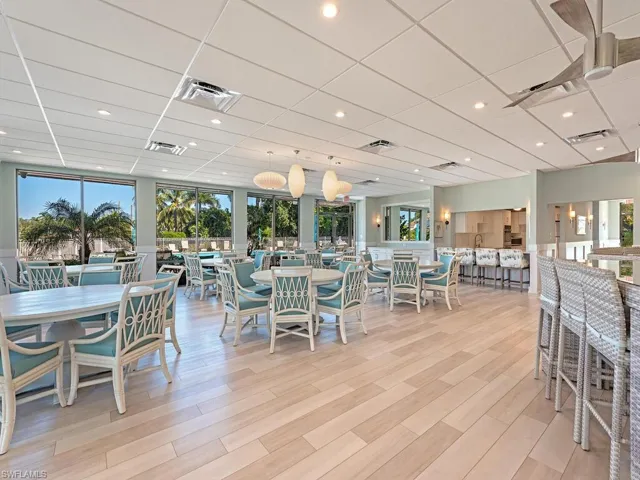 Club House with a drop ceiling, light wood-style floors, and recessed lighting