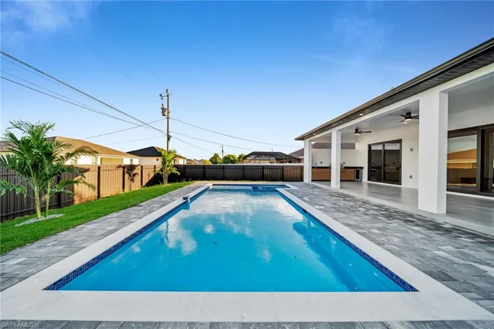 View of swimming pool featuring a patio, a fenced backyard, and ceiling fan