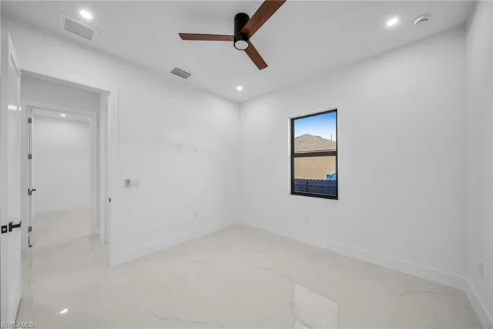 Empty room with light marble finish flooring, recessed lighting, and ceiling fan
