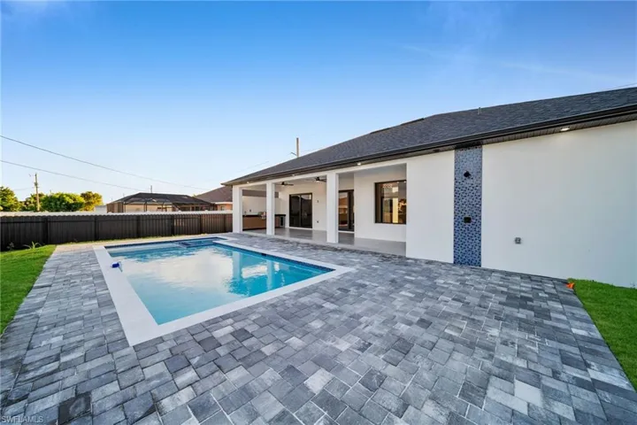View of pool featuring a patio, a fenced backyard, and a ceiling fan