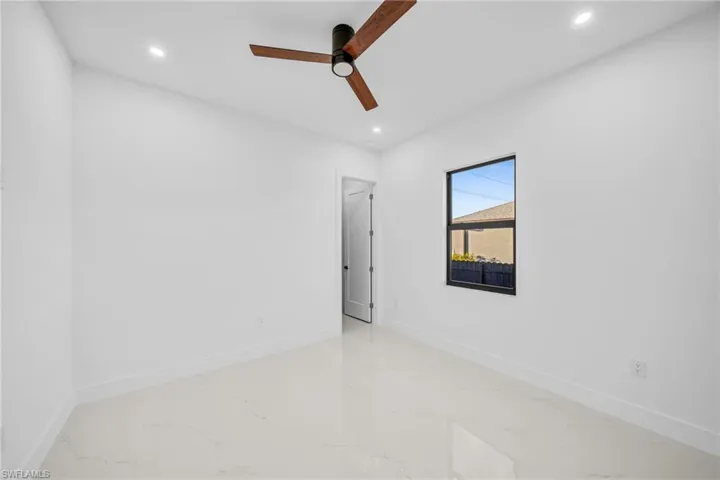 Unfurnished room featuring recessed lighting, light marble finish floors, and a ceiling fan