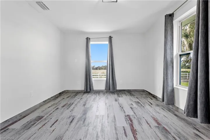 Empty room featuring light hardwood / wood-style floors and a healthy amount of sunlight