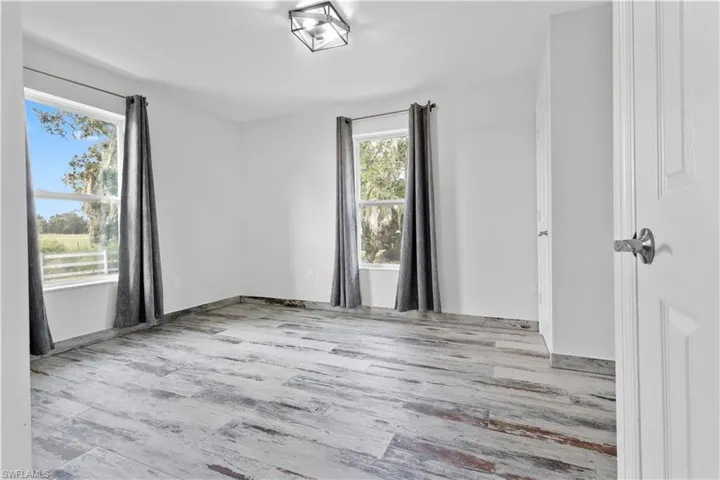 Spare room featuring light wood-type flooring