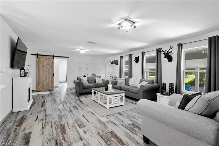 Living room featuring a barn door and light wood-type flooring