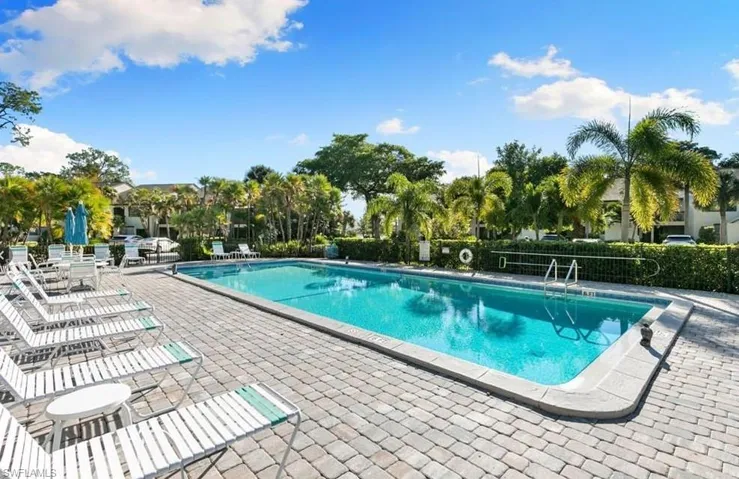Community pool with a patio
