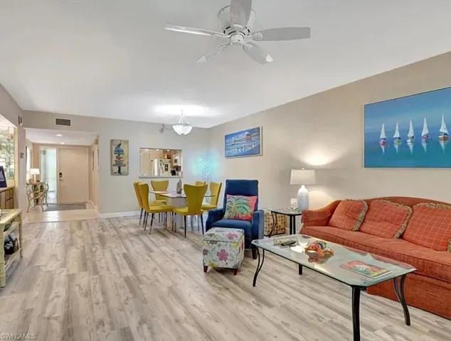 Living area featuring light wood-type flooring and a ceiling fan