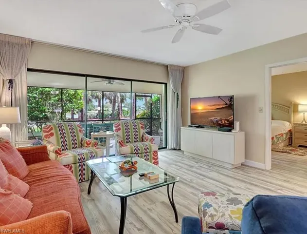Living area featuring wood finished floors and a ceiling fan