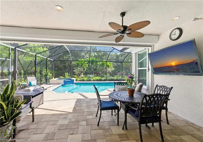 View of swimming pool with a patio, a sunroom, a pool with connected hot tub, and a lanai