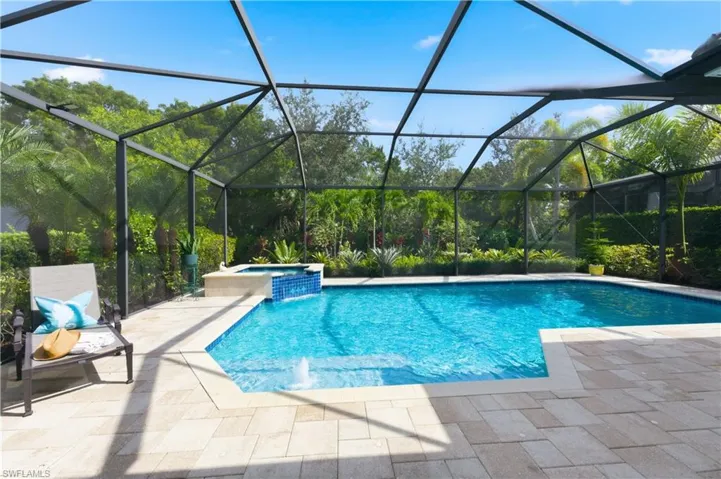 View of pool featuring a pool with connected hot tub, a sunroom, a lanai, and a patio