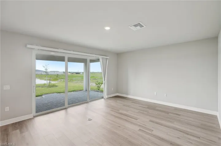 Spare room featuring baseboards, light wood-style floors, and recessed lighting