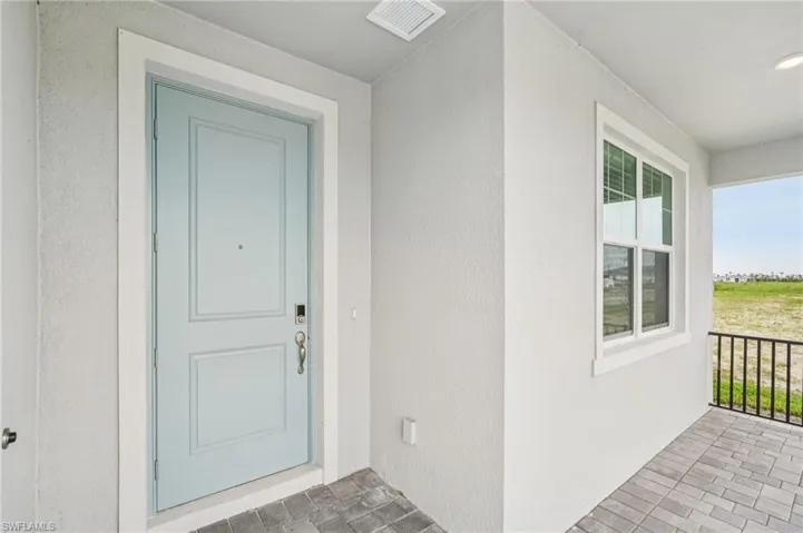 Entrance to property with stucco siding