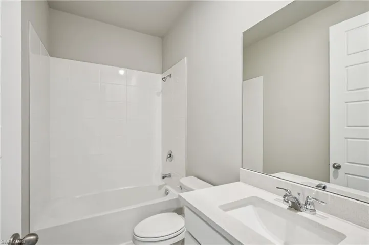 Full bath with toilet, vanity, and shower / bathtub combination