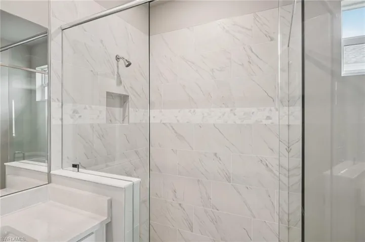 Full bathroom featuring a stall shower and vanity