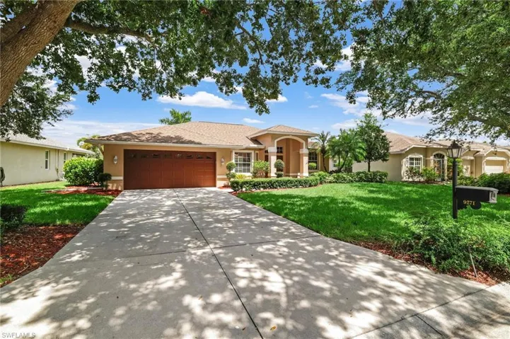 Mediterranean / spanish home with stucco siding, an attached garage, a front lawn, and concrete driveway