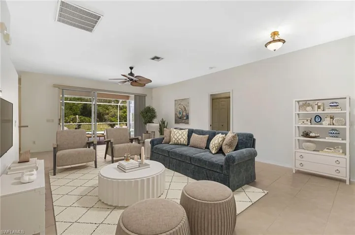 Living area with ceiling fan and light tile patterned floors