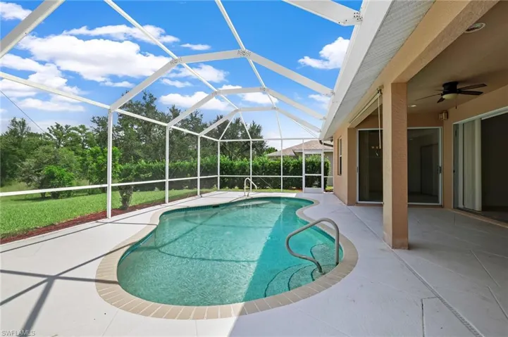 Swimming pool with a patio area and ceiling fan