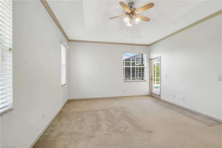 Unfurnished Primary bedroom showing access to the outdoor pool area.