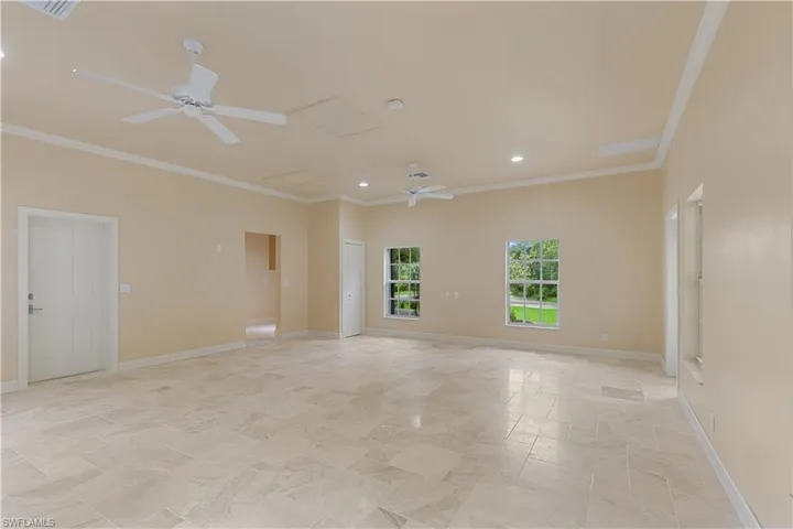 Spare room featuring ceiling fan, ornamental molding, recessed lighting, and baseboards