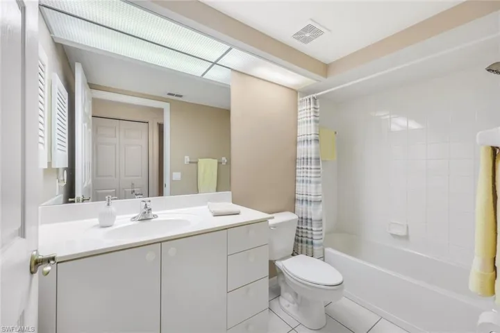 Full bathroom featuring tile patterned floors, vanity, toilet, and shower / bath combo