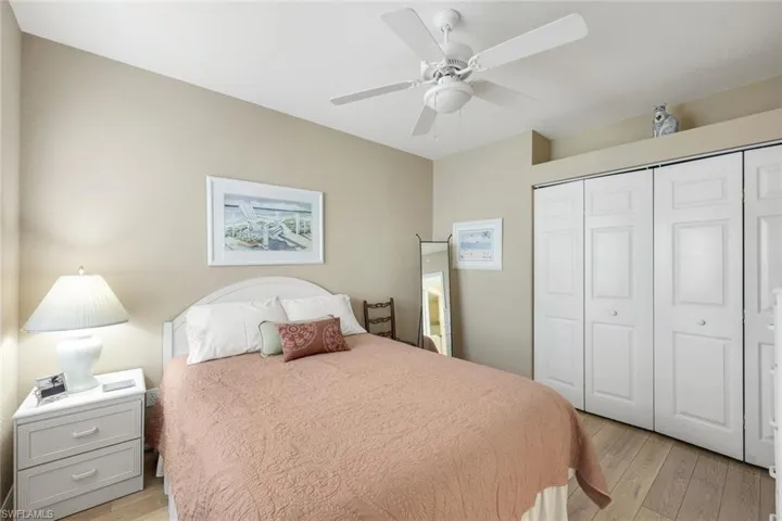 Bedroom featuring ceiling fan, a closet, and light hardwood / wood-style floors