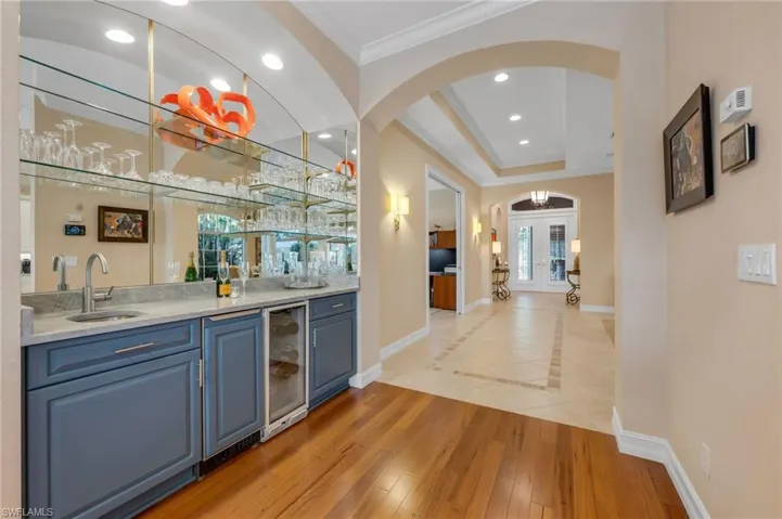 Completely remodeled bar is perfectly placed off the kitchen and family room.