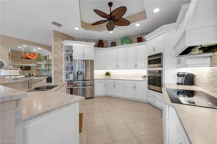 The remodeled kitchen has an induction top, quartzite counters, and abundant storage.