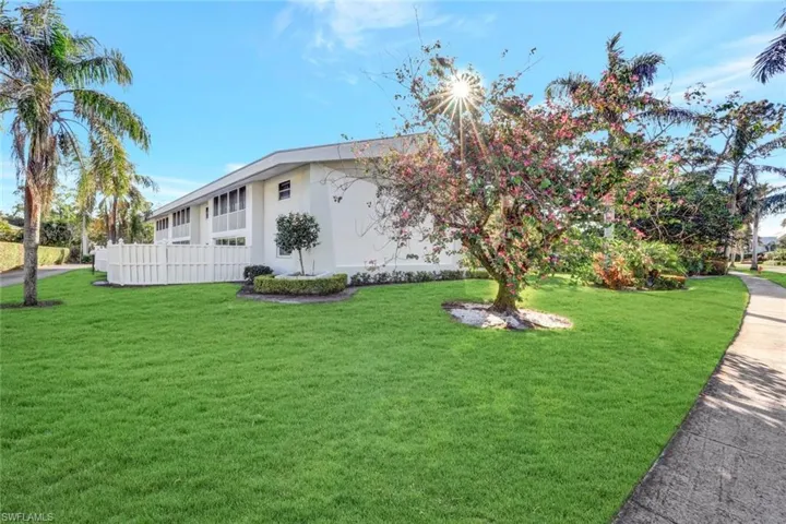 View of property exterior featuring a lawn