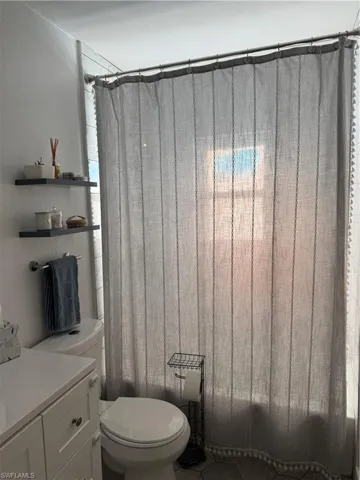 Full bathroom with shower / bath combination with curtain and vanity