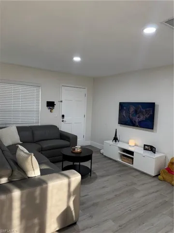 Living room featuring wood finished floors and recessed lighting