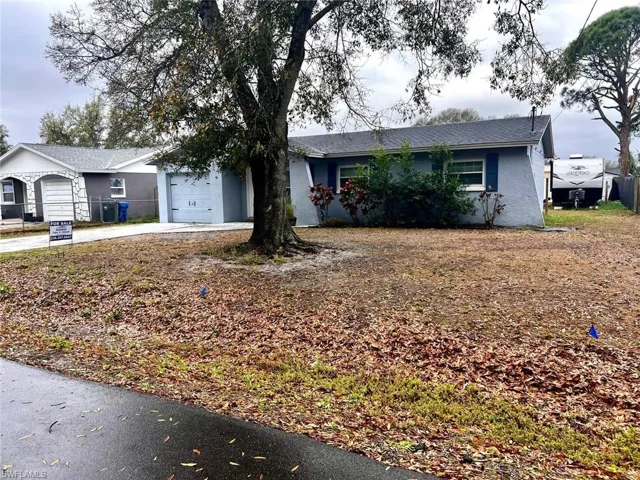 Single story home featuring concrete driveway, a garage, and stucco siding
