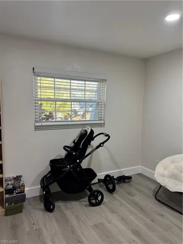 Exercise room with light wood-style floors